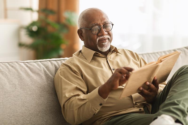 Older man reading on couch